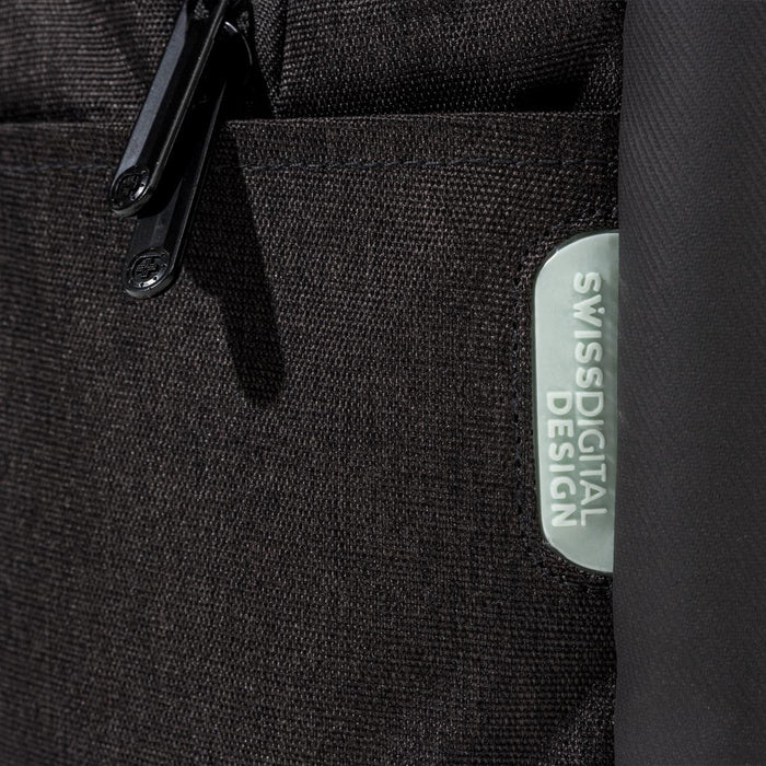 Swissdigital Arosa Backpack - A close-up of a black backpack featuring a textured fabric and a logo patch.