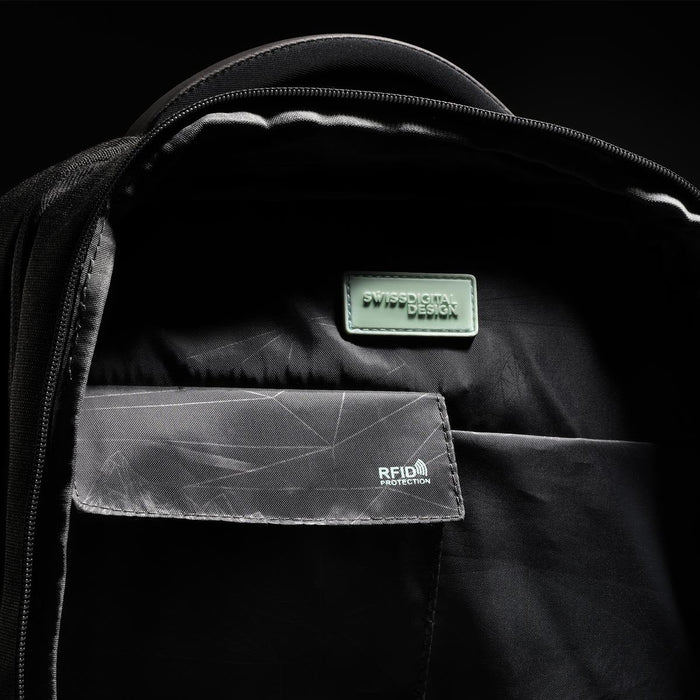 Swissdigital Arosa Backpack - An interior view of a black backpack featuring compartments, a logo, and RFID protection detailing.