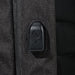 Swissdigital Arosa Backpack - A close-up of a feature on a black backpack, showcasing a zipper pull and textured fabric.