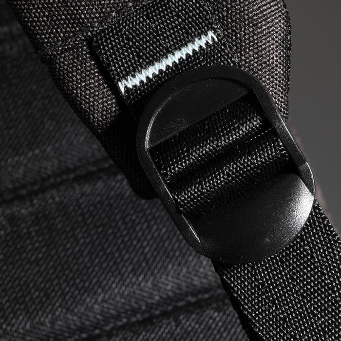 Swissdigital Arosa Backpack - A detailed close-up of a black backpack strap featuring a plastic buckle, showcasing its durable materials and design.