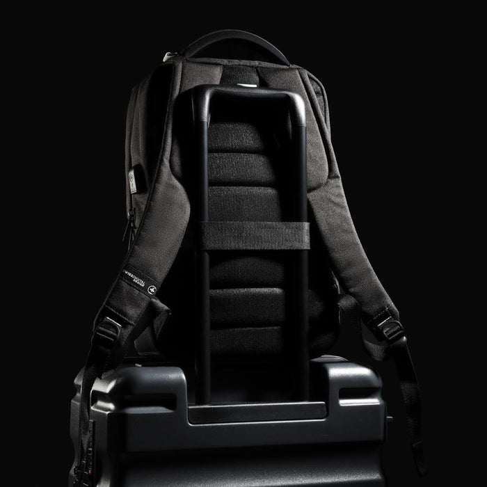 Swissdigital Arosa Backpack - A black Swissdigital Arosa Backpack rests on a suitcase, featuring straps and a sleek design.