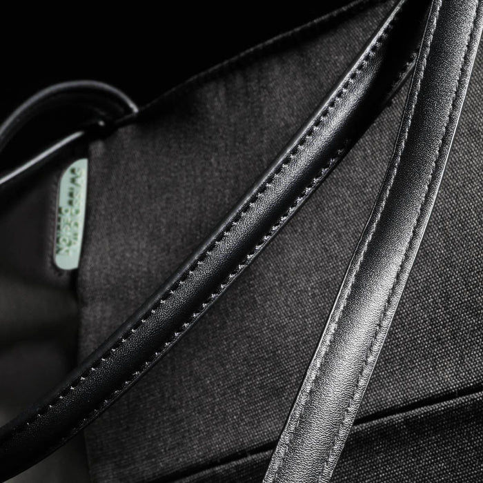 Swissdigital Arosa Tote Bag - A black tote bag featuring a smooth, sleek handle and a subtle logo. The fabric has a textured finish.