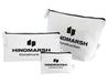 Calico Travel Set - A set of three white bags with black zippers and a logo, varying in size.