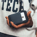 Thread Zipper Wallet - A hand holding a black and grey Thread Zipper Wallet, featuring a zippered compartment and a card slot.