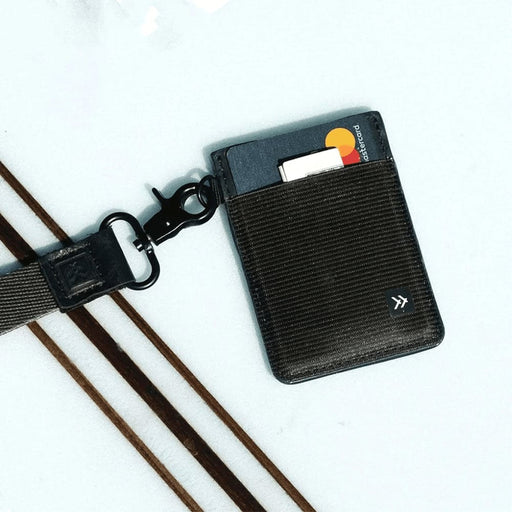 Thread Vertical Wallet - A black vertical wallet with a textured front, featuring a card slot and an attached clip for easy attachment.