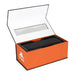 Trekk Outdoor Speaker & Wireless Powerbank - A black outdoor speaker and wireless power bank in an open orange box with a clear plastic window and branding.