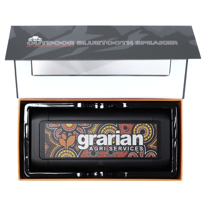 Trekk Outdoor Speaker & Wireless Powerbank - A black outdoor Bluetooth speaker with a colourful Aboriginal art design, presented in a sleek box with branding.
