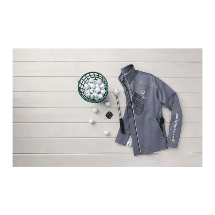 Men's Senger Knit Full Zip Performance Jacket w/ Thumb Holes - A grey full zip performance jacket with thumb holes and a logo, placed beside a basket of golf balls.