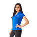 Women's Piedmont Short Sleeve Performance Polo - A woman wearing a blue short sleeve performance polo shirt with a logo on it, paired with black pants.