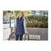 Women's Telluride Lightweight Packable Insulated Puffer Vest - A woman wearing a navy insulated puffer vest over a grey top, standing outdoors with greenery in the background.