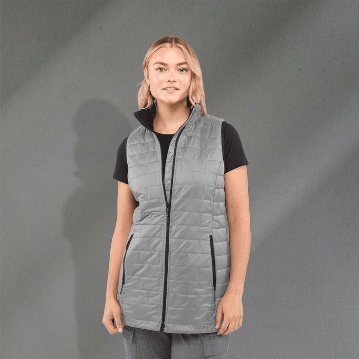 Women's Telluride Lightweight Packable Insulated Puffer Vest - A lightweight, packable insulated puffer vest in grey, featuring a zip front and side pockets, worn over a black shirt.