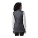 Women's Telluride Lightweight Packable Insulated Puffer Vest - A woman wearing a dark grey lightweight packable insulated puffer vest, viewed from the back. The vest has a logo.