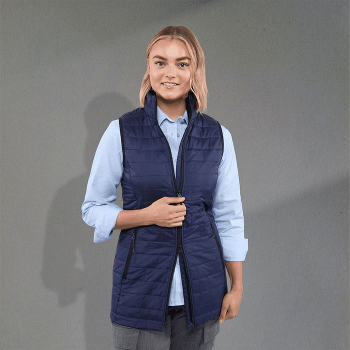 Women's Telluride Lightweight Packable Insulated Puffer Vest - A navy insulated puffer vest with a zip front and side pockets, worn over a light blue shirt.
