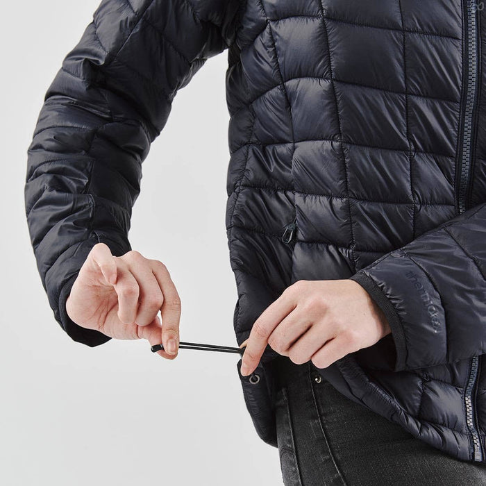Women's Tundra Thermal Jacket - A black women's puffer jacket, featuring a zippered front and drawstring adjustments at the hem.