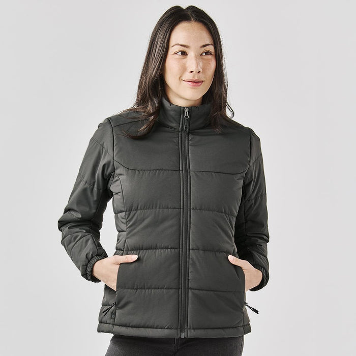 Women's Sierra Thermal Jacket - A women's puffer jacket in dark grey with a zip front, featuring side pockets and a high collar, with branding.
