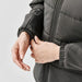 Women's Sierra Thermal Jacket - A close-up of a woman's hands adjusting the cuff of a women's grey puffer jacket. The jacket has a logo.