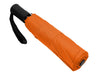 Como Fold-Up Umbrella - An orange fold-up umbrella with a black handle and strap, securely closed and compact for easy carrying.