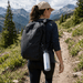 Thunder 600ml Bottle - A drink bottle in silver hanging from a backpack, with a mountainous landscape in the background.