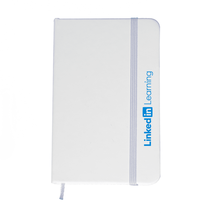 Minichroma A6 Notebook - A white A6 notebook with a blue elastic band and branding on the side.