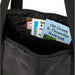 Wander & Roam Packable Travel Duffel Bag - A black duffle bag interior with various pamphlets and brochures visible inside.