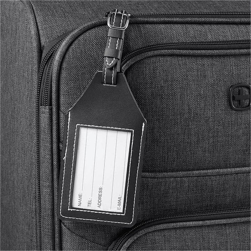 Wander & Roam Luggage Tag w/ AirTag Holder - A black luggage tag attached to a grey suitcase, featuring a clear window for personal information.